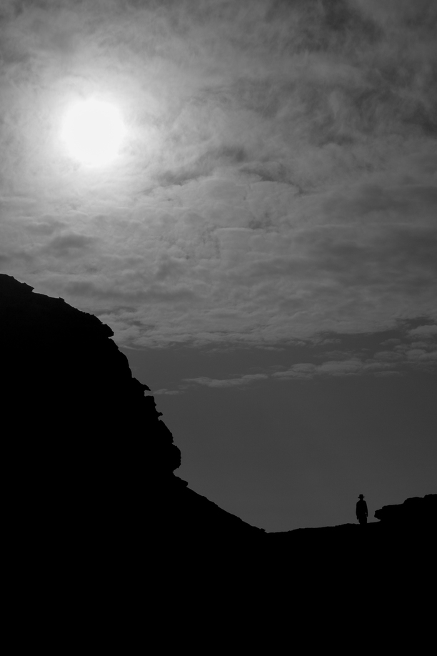 A sole figure disappears amongst the sandstone in Wadi Rum, Jordan