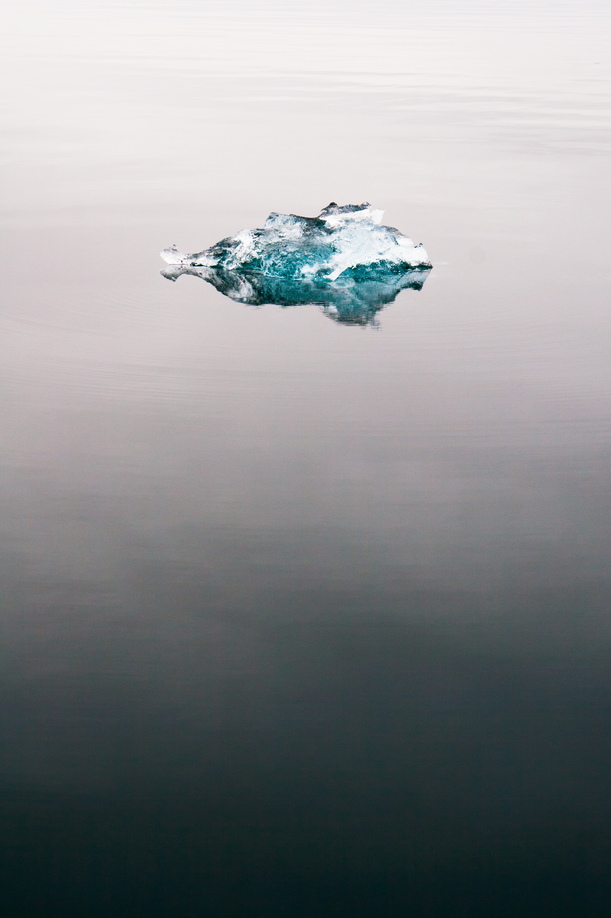 An ice cube hangs the ocean near Ny-Ålesund.