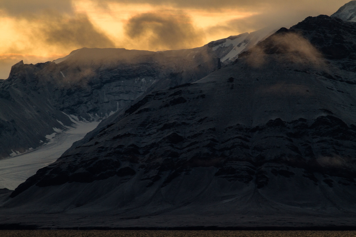 Ice?  Scree?  Rock?  Black hills interupt the glacial white in St Johnsfjorden / Prins Karls Forland in Svalbard